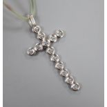 A modern Italian Fope 18ct white gold and gem set articulated cross pendant, on a plastic?