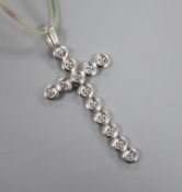 A modern Italian Fope 18ct white gold and gem set articulated cross pendant, on a plastic?