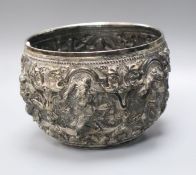 A 19th century Burmese embossed white metal bowl, decorated with figures and scrolls, height 10cm.