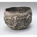 A 19th century Burmese embossed white metal bowl, decorated with figures and scrolls, height 10cm.