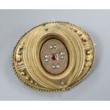 A Victorian yellow metal seed pearl and ruby set oval brooch, with glazed back, 42mm.