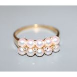 A modern Mikimoto 18ct gold, ten cultured pearl and four stone diamond set half hoop dress ring,