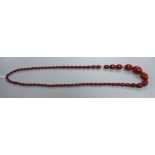 A single strand simulated cherry amber oval bead necklace, gross weight 93 grams, 100cm.