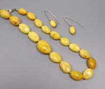 A single strand graduated amber bead necklace and pair of similar earrings, gross weight 36 grams,