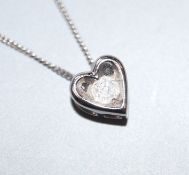 A modern 9ct white gold and diamond set heart shaped pendant necklace, pendant 6mm.
