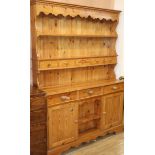 A Victorian style pine dresser with boarded rack W.140cm