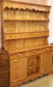 A Victorian style pine dresser with boarded rack W.140cm