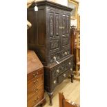 An 18th century large oak cupboard, fitted doors over one long and five short drawers, all later