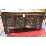 A late 17th century carved and panelled oak coffer, with planked top W.124cm