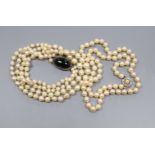 A double strand cultured pearl necklace, with cabochon clasp and a single strand cultured pearl