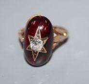 A star-set diamond and garnet cabochon ring, yellow metal setting (tests as 9ct), size J.