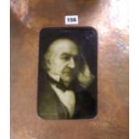 A Sherwin and Cotton ceramic portrait tile of Gladstone in an Arts and Crafts coppered frame