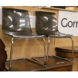 A pair of smoked perspex and chrome cantilever chairs