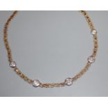 A modern 9ct gold and collet set five stone diamond necklace, 39cm.