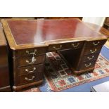 A George III style mahogany pedestal desk with gilt tooled burgundy leather top W.154cm