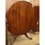 A George III style mahogany circular tilt top breakfast table (the base wormed) Diameter 102cm