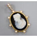 A late 19th century continental yellow metal and split pearl set sardonyx cameo pendant, 58mm
