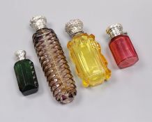 Four assorted late Victorian silver or white metal mounted coloured glass scent bottle including two