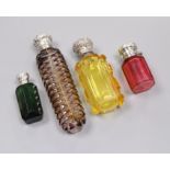 Four assorted late Victorian silver or white metal mounted coloured glass scent bottle including two