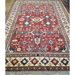 A Kazak red ground carpet 220 320cm