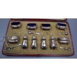A cased matched early 20th century ten piece silver cruet set.