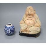 A Chinese Buddha and a blue and white vase