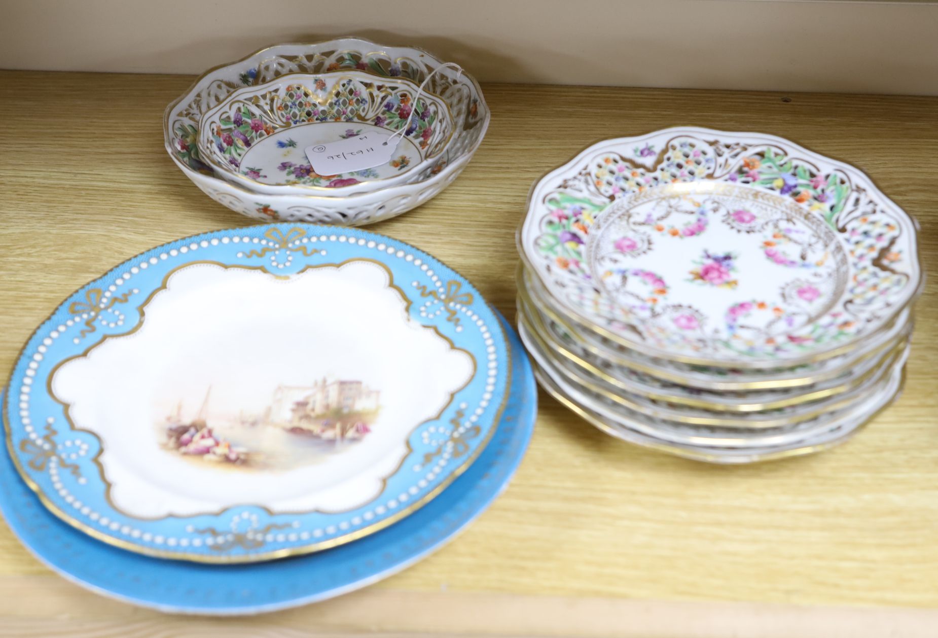 A set of six pierced Dresden plates with two matching graduated bowls and two Continental cabinet