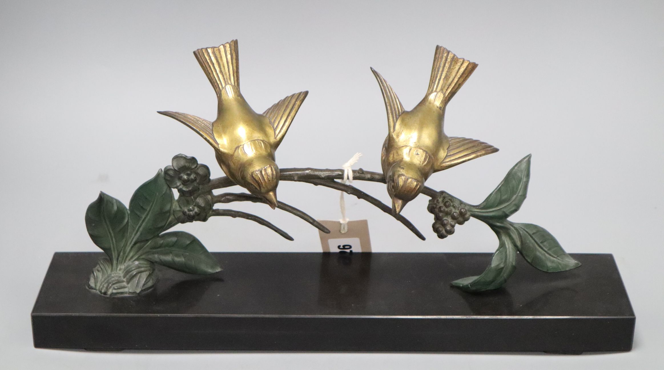 Plagnet, spelter of two birds on a branch, on a black slate base, signed W.40cm Length of base 40cm