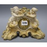 A painted alabaster cherub clock