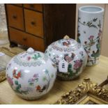 A pair of Chinese lidded jars with cockerel motif and a similar vase