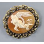 A yellow metal mounted ova shell cameo brooch, carved with Nyx, Goddess of the Night with her