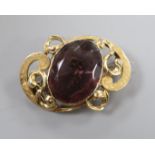 An Edwardian engraved yellow metal mounted amethyst paste set scroll brooch, 43mm.