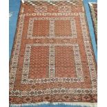 An Afghan terracotta ground rug 180 x 120cm