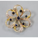 A 750 yellow metal, sapphire and diamond set openwork flower head pendant, 24mm.