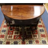 An 18th century mahogany demi lune folding tea table W.76cm