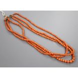 An early-mid 20th century triple strand graduated coral bead necklace, with yellow metal and coral