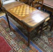A Regency mahogany writing / games table with reversible leather lined chequer surface with interior