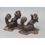 A pair carved coat hangers - a tiger and a gargoyle both with glass eyes L.21cm. W.14cm, D.18cm