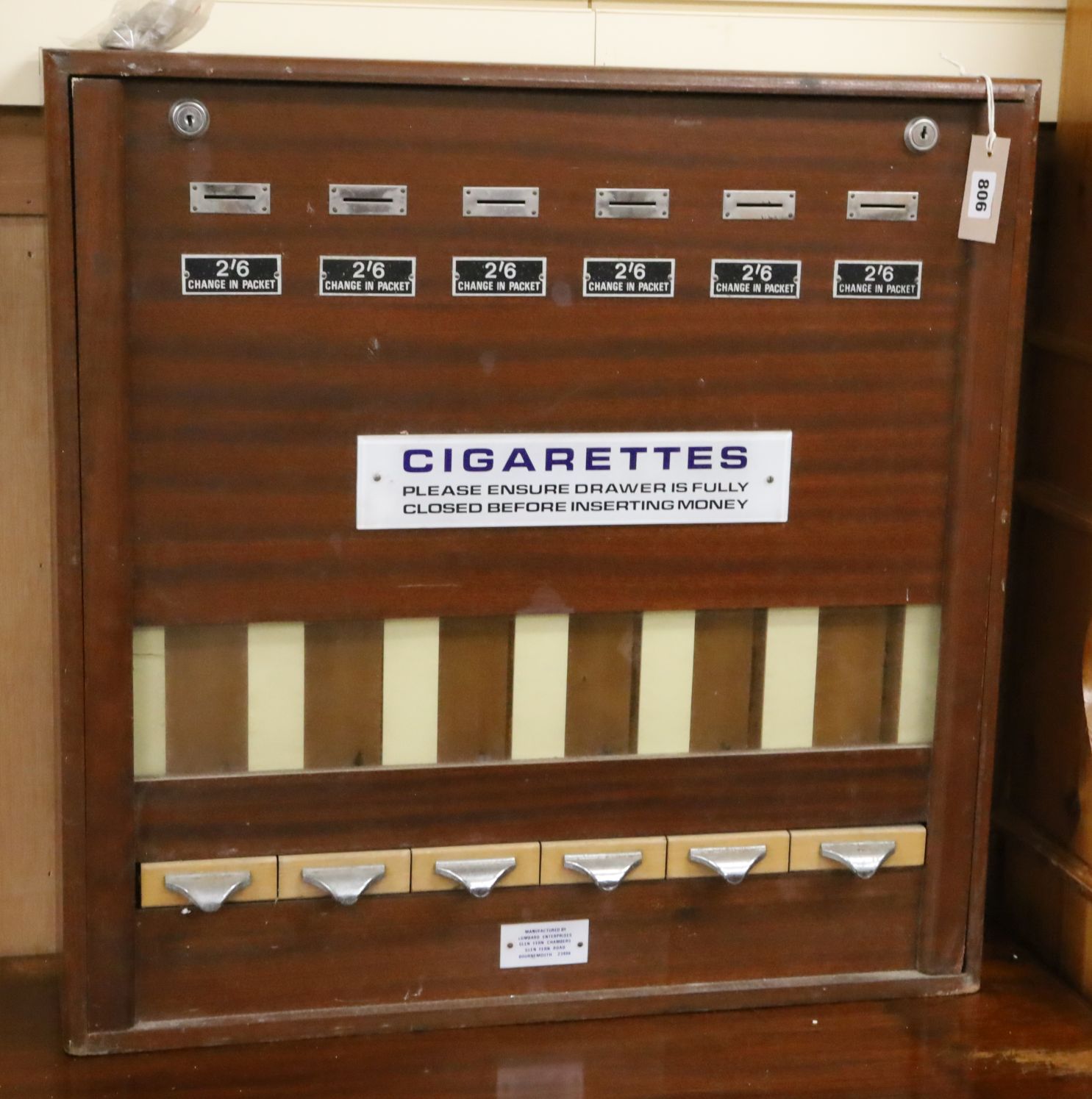 A cigarette vending machine W.67cm