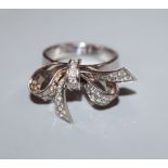 A modern Ritz of London 18ct white gold and pave set diamond ribbon bow dress ring, total diamond