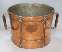 A hammered Arts and Crafts copper drum shaped two handled pot handle to handle 44cm