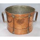 A hammered Arts and Crafts copper drum shaped two handled pot handle to handle 44cm