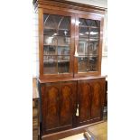 A Victorian mahogany library bookcase, the base fitted with an arrangement of twenty two drawers