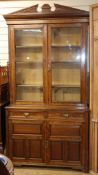 A James Shoolbred walnut bookcase / cabinet W.120cm