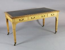 A late Victorian Gillows of Lancaster oak writing table, with gilt black leather skiver and three