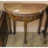 An 18th century mahogany triple folding tea / card table W.75cm