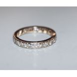 A white metal and diamond set full eternity ring, set with twenty round cut stones, size P/Q.