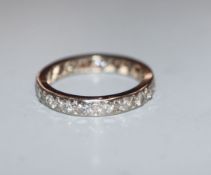 A white metal and diamond set full eternity ring, set with twenty round cut stones, size P/Q.