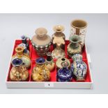 Thirteen Doulton miniature vases and a jug