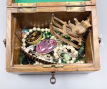 A wooden box containing assorted jewellery etc.